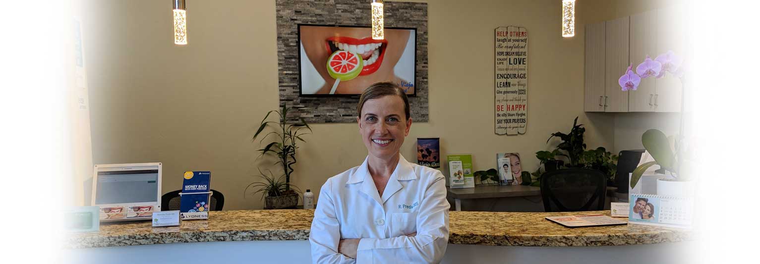 Dr. Ruxandra Preda welcoming patients at the Aliso Viejo Dental reception desk